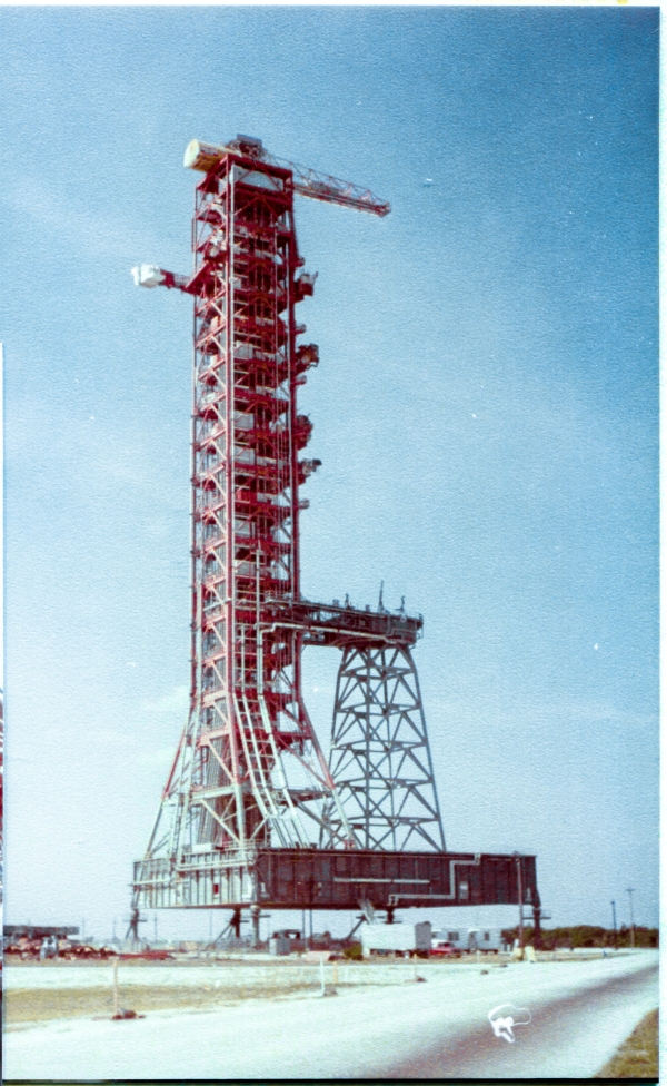 Mobile Launcher 1, seen here at the Park Site north of the VAB. This is the Saturn V launch platform which the crew of Apollo 11, the first humans to depart this planet and land on the Moon, flew from. Following that, it was modified with the addition of the “Milk Stool” which permitted its use for the much-smaller Saturn 1B’s which took the crews of Skylab and Apollo-Soyuz into orbit. Photograph by James MacLaren.